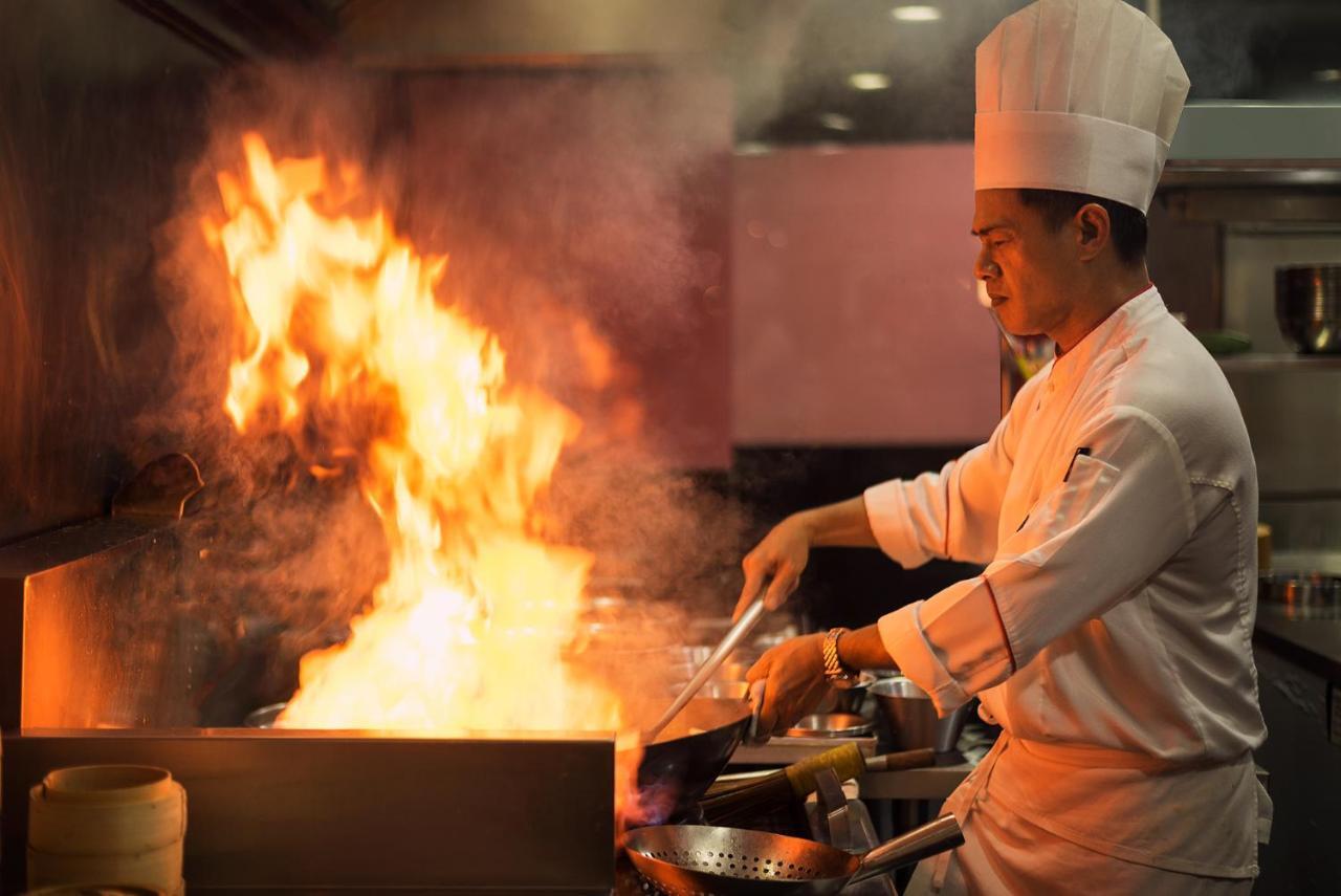 The Berkeley Hotel Pratunam Bangkok Exterior foto A chef cooking with a wok